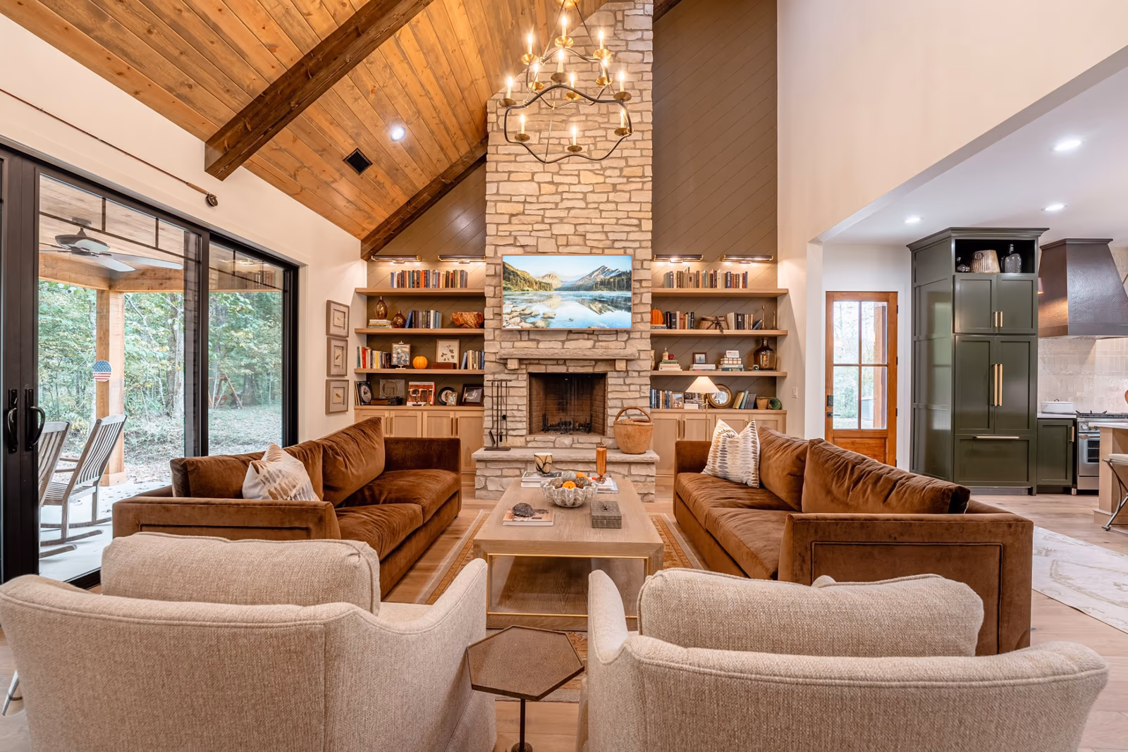 Lodge-style great room with a wood ceiling and stone fireplace at Trout Water Bend