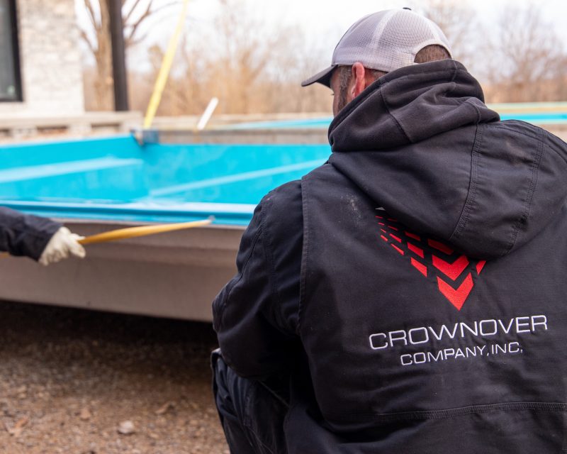 Crownover Company crew member working on a custom pool installation
